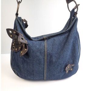 Denim crossbody bag w/faux brown leather flowers & brass grommet & stud deco.